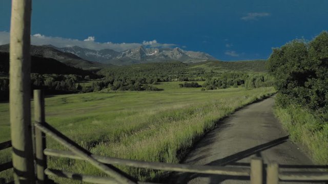Double RL ranch gate of Ralph Lauren ranch leads to Indian Tepees, under San Juan Mountains
