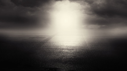 Dramatic black and white background. Cloudy night sky, moonlight, reflection on the pavement. Smoke and fog on a dark street at night.