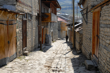 Fototapeta na wymiar Lahic village, Azerbaijan, Caucasus - April, 2008: Authentic Azerbaijani old man on the street of the village.