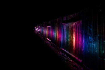 Beautiful RGB light painting along a fence at night time