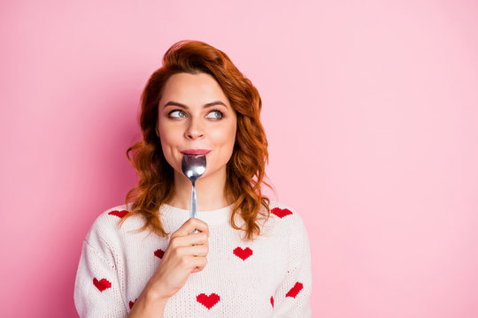 Close-up portrait of her she nice attractive pretty cute dreamy cheerful wavy-haired girl licking spoon fantasizing creating recipe festal lunch breakfast isolated on pink pastel color background