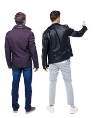 Back view of two man in winter jacket showing thumb up.