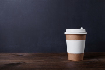 Cup of coffee on blackboard background.