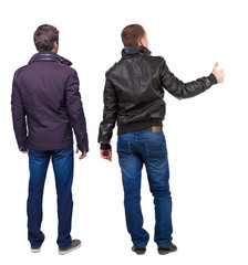 Back view of two man in winter jacket showing thumb up.