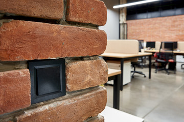Black switches on a brick wall in a loft style in a large office