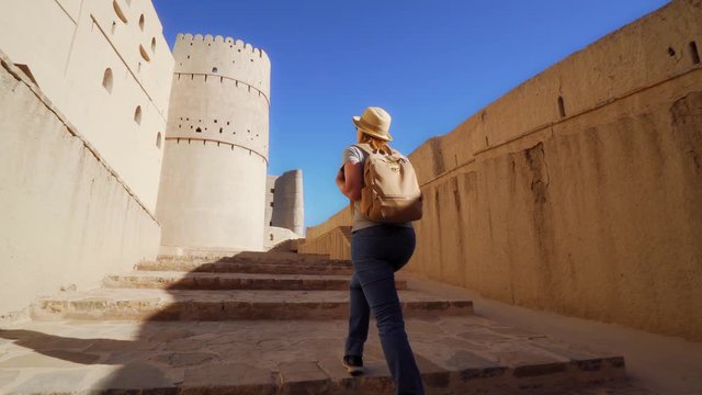 Young Foreign Female Tourist Visiting Ancient Bahla Fort in Oman