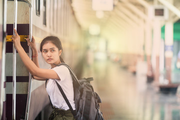 asian girl with backpack, travel by train, destination nature trip in summer