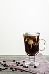 Cold coffee with ice and cream, on wooden background