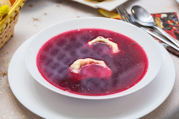 Festive table with traditional red borscht with dumplings
