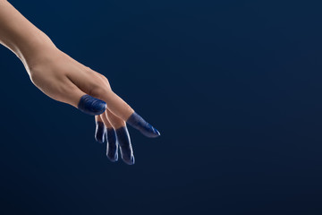 cropped view of female hand with painted fingers isolated on blue