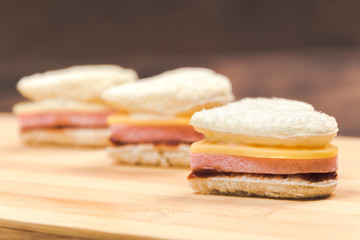 Heart shaped sandwich recipe, ingredients with sauces on a wooden board. Horizontal, close up, selective focus