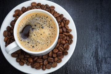 Coffee cup and saucer on a wooden table. Dark background.