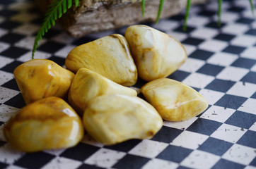 Large Tumbled Yellow Jasper! Creamy, yellow swirls. Beautiful intricate yellow jasper, great for detox and strength. Witches healing crystal. Vintage styled photo with lush colors, natural lighting. 