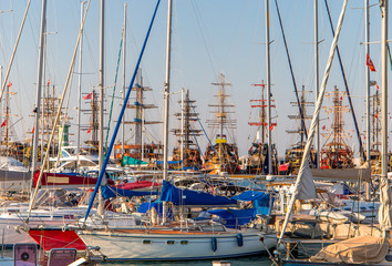 Yachts and boats in the seaport on a summer day.