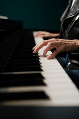 Fototapeta na wymiar Woman hands playing keyboard at the studio