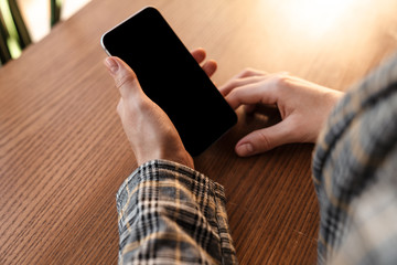 Cropped photo of caucasian young woman using cellphone