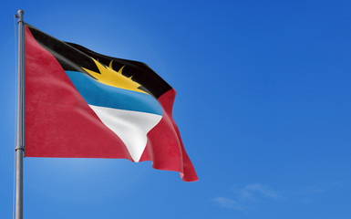 Antigua and Barbuda flag waving in the wind against deep blue sky. National theme, international concept. Copy space for text.