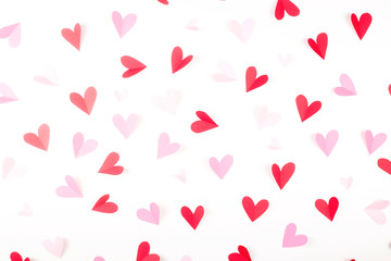 Red and pink hearts made of paper on a white background. Valentine's day and love concept.