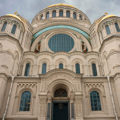 Fototapeta na wymiar Front view of a fragment of the facade of the Naval Cathedral in Kronstadt, Russia against a gray autumn sky