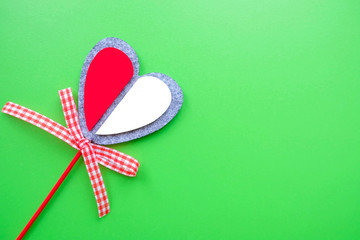 Valentine card on a green background. Heart on a stick