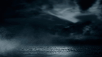Naklejka na ściany i meble Dramatic black and white background. Cloudy night sky, moonlight, reflection on the pavement. Smoke and fog on a dark street at night.