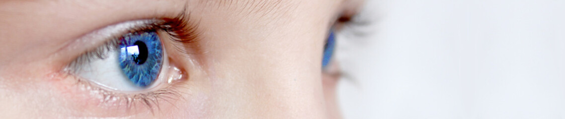 Blue eyes close up. Fresh outlook on life. Naturalness. Children's look. Concept for cosmetics....