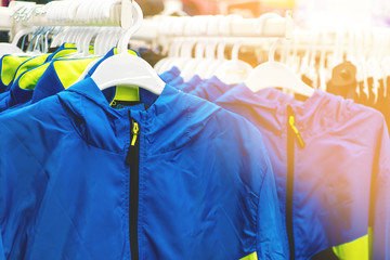 blue sports windbreaker on the counter of a children's clothing store. clothing for boys in the...