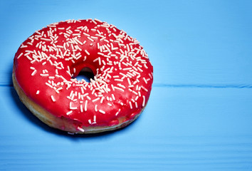 pink glazed donut on a blue background