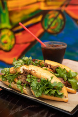 Vietnamese traditional sandwich, pork Banh-mi with black coffee. Two vietnamese foods on a tray.