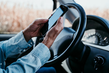 young beautiful woman using mobile phone in a car. travel concept