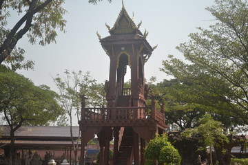 The picture of the bell tower is made of patterned wood.