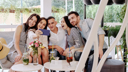 Group of friends makes selfie in at cafe