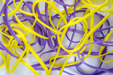 pile of colorful small rubber bands isolated on a white back ground
