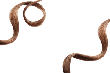 Brown hair on white, isolated. Thin curly threads as background