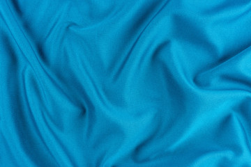 Bright blue fabric texture with folds.