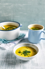 Cream of potato and leek soup with turmeric, topped with fresh parsley