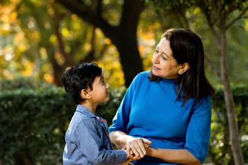 Obraz premium Loving grandmother playing with her grandson at park