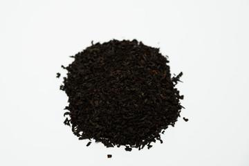 a handful of dried tea leaves sprinkled with a slide on a white background