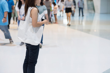 Woman hand holding Eco Shopping bag in store background with Copy space for text. Environmental Protection, Zero waste, Reusable, Say No Plastic, World Environment day and Earth day concept