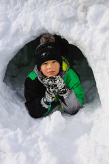 Boy building an igloo for fun.