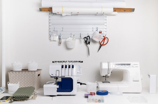 Workplace: White table with a sewing machine and an overlock for sewing.