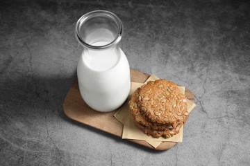 Chocolate and sunflower seed cookies with milk in glass bottle, Cookies and milk on rustic background