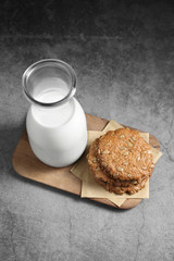 Chocolate and sunflower seed cookies with milk in glass bottle, Cookies and milk on rustic background
