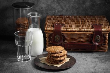 Chocolate and sunflower seed cookies with milk in glass bottle, Cookies and milk on rustic background