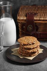 Chocolate and sunflower seed cookies with milk in glass bottle, Cookies and milk on rustic background