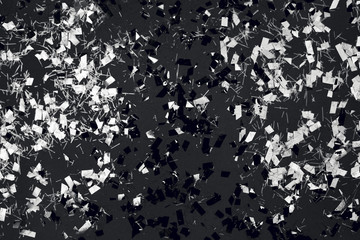 Black and white confetti on a background.