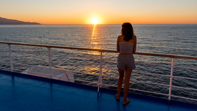 Asian Teen In Tube Top Standing On Deck Of Ferry Looking At Sunset