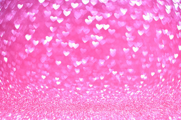 Abstract vintage background from glitter pink bokeh lights in the shape of a heart, blurred background