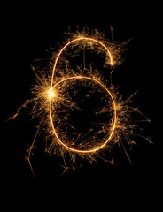 Digit 6 or six made of bengal fire, sparkler fireworks candle isolated on a black background. Party dark backdrop.