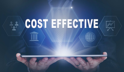 Businessman holding a computer tablet display projecting a Cost Effective concept.
